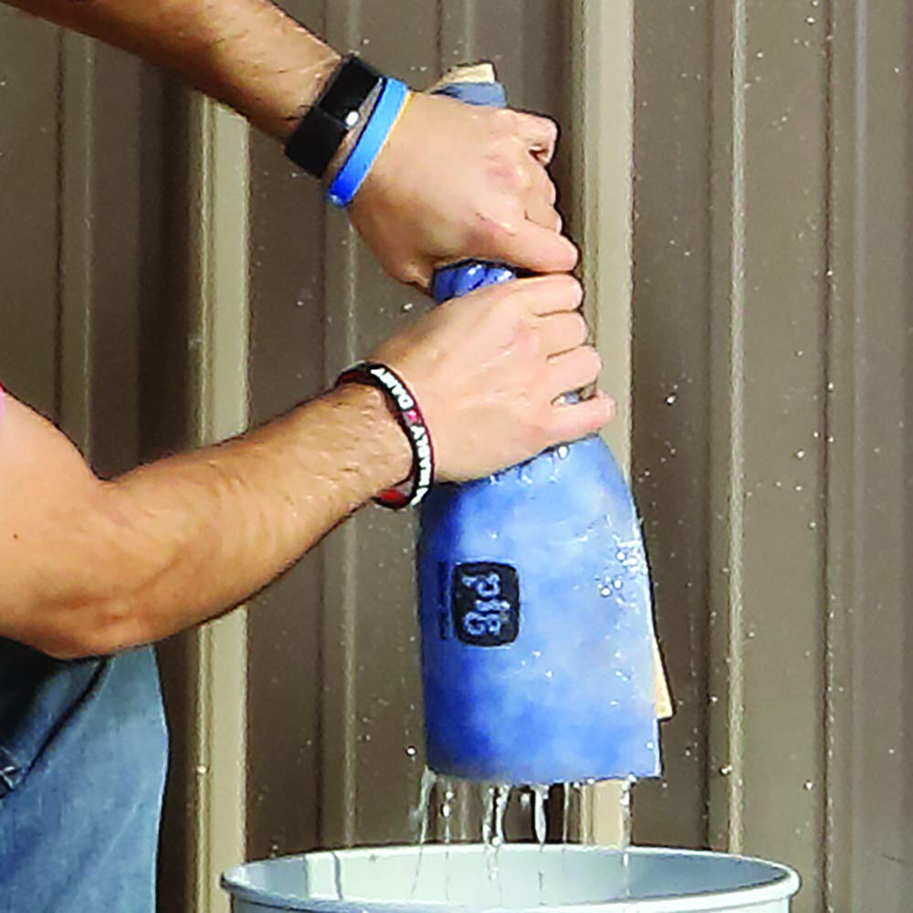 PIG mat soaking water on a garage floor for quick puddle removal