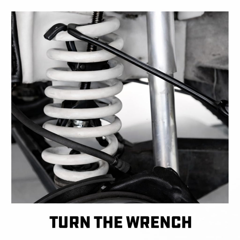 Powerbuilt next to coil spring for scale, shows compatibility and capacity