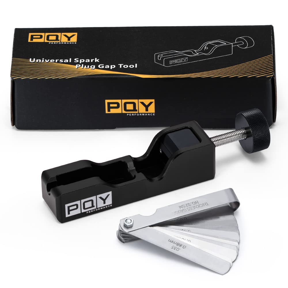 PQY tool on a workbench with spark plugs showing practical garage use