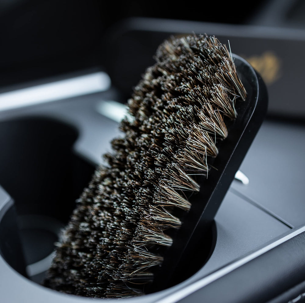 PROPER DETAILING CO. brushes staged with cleaner bottle for product use