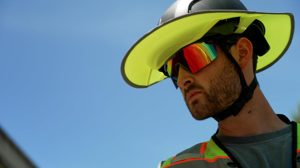 Pyramex SB11295ST on worker outdoors reducing glare and protecting eyes on bright jobsite benefit