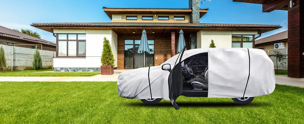 Qualencey silver cover on driveway protecting vehicle from sun and debris