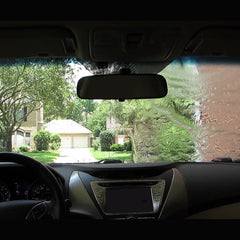 Rain‑X being sprayed on a motorcycle windscreen to enhance visibility while riding