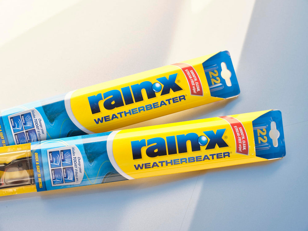 Rain‑X blades clearing windshield water while driving, improved visibility in wet conditions