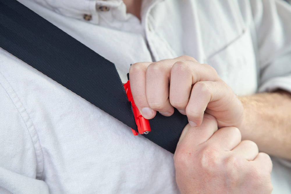 RESQME cutting a seatbelt in a demo to show rapid release advantage