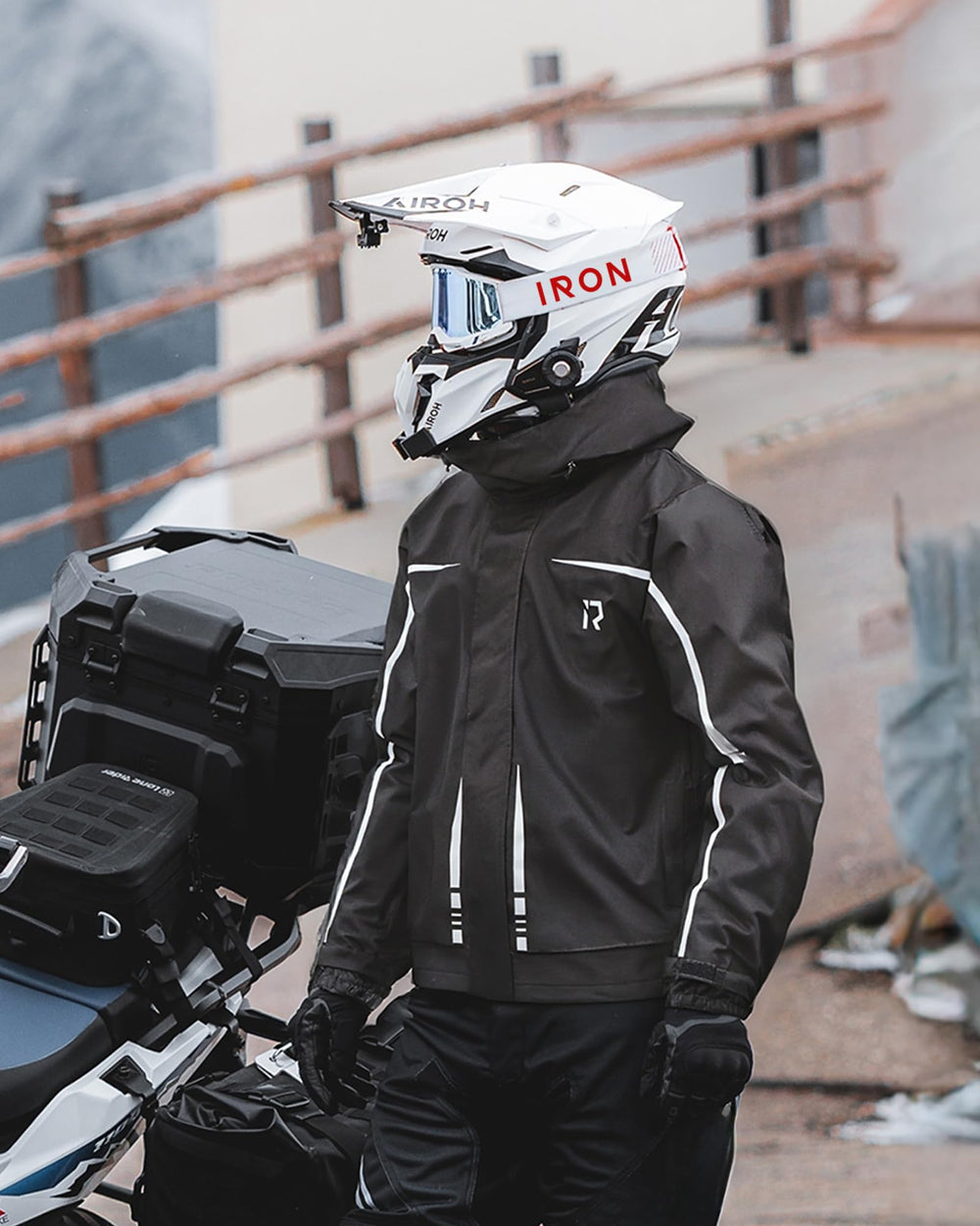 RIDEIRON model on motorcycle in rain demonstrating riding protection and mobility