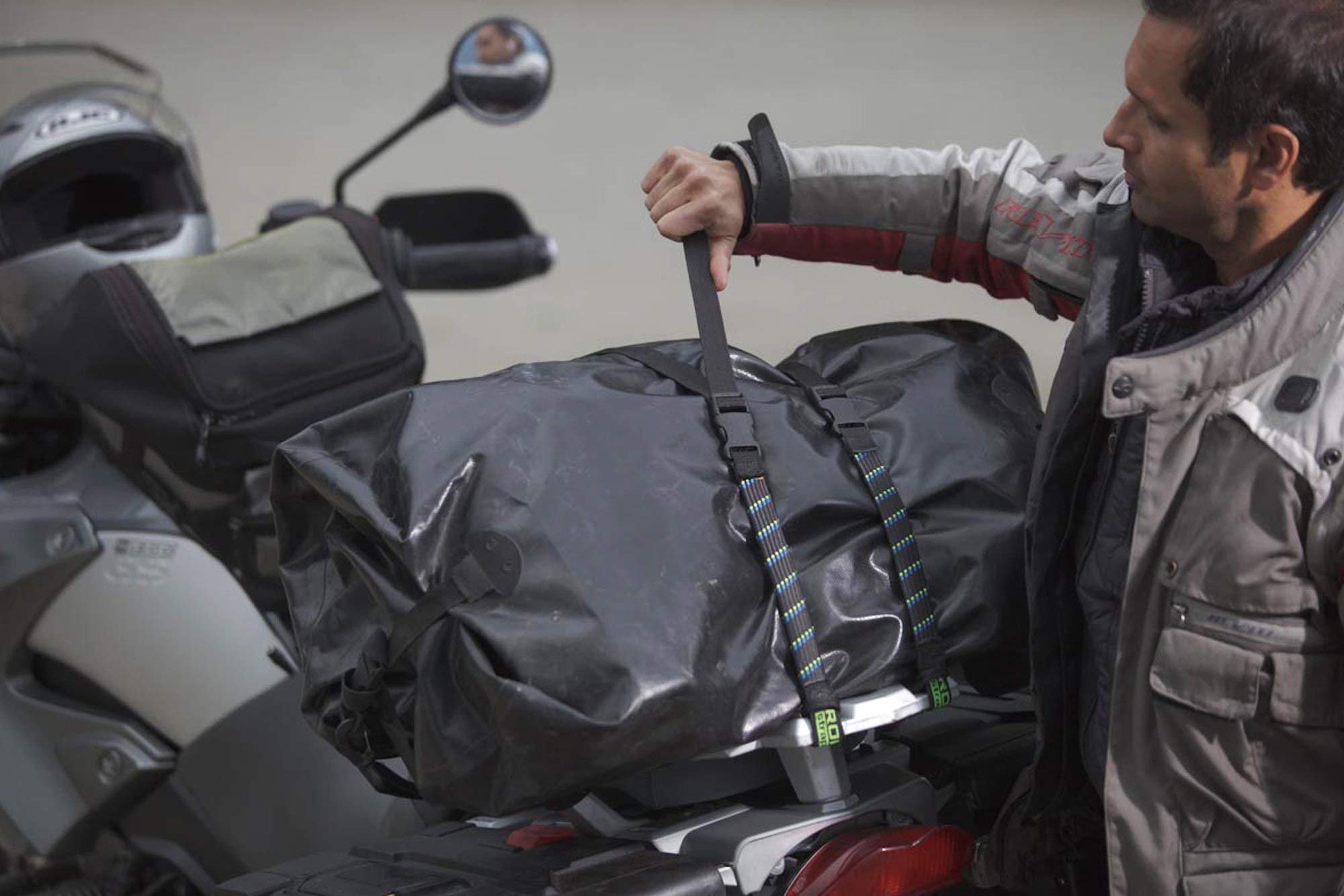 ROK Straps securing motorcycle luggage on rear rack, keeps cargo stable