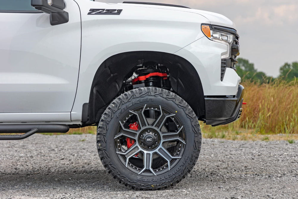 Rough Country-equipped Silverado driving on road showing upgraded appearance