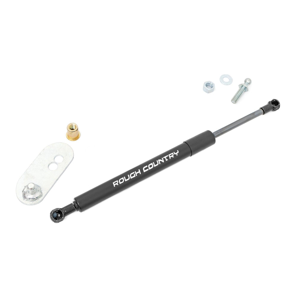 Rough Country tailgate assist next to ruler for scale illustrating compact, strong unit