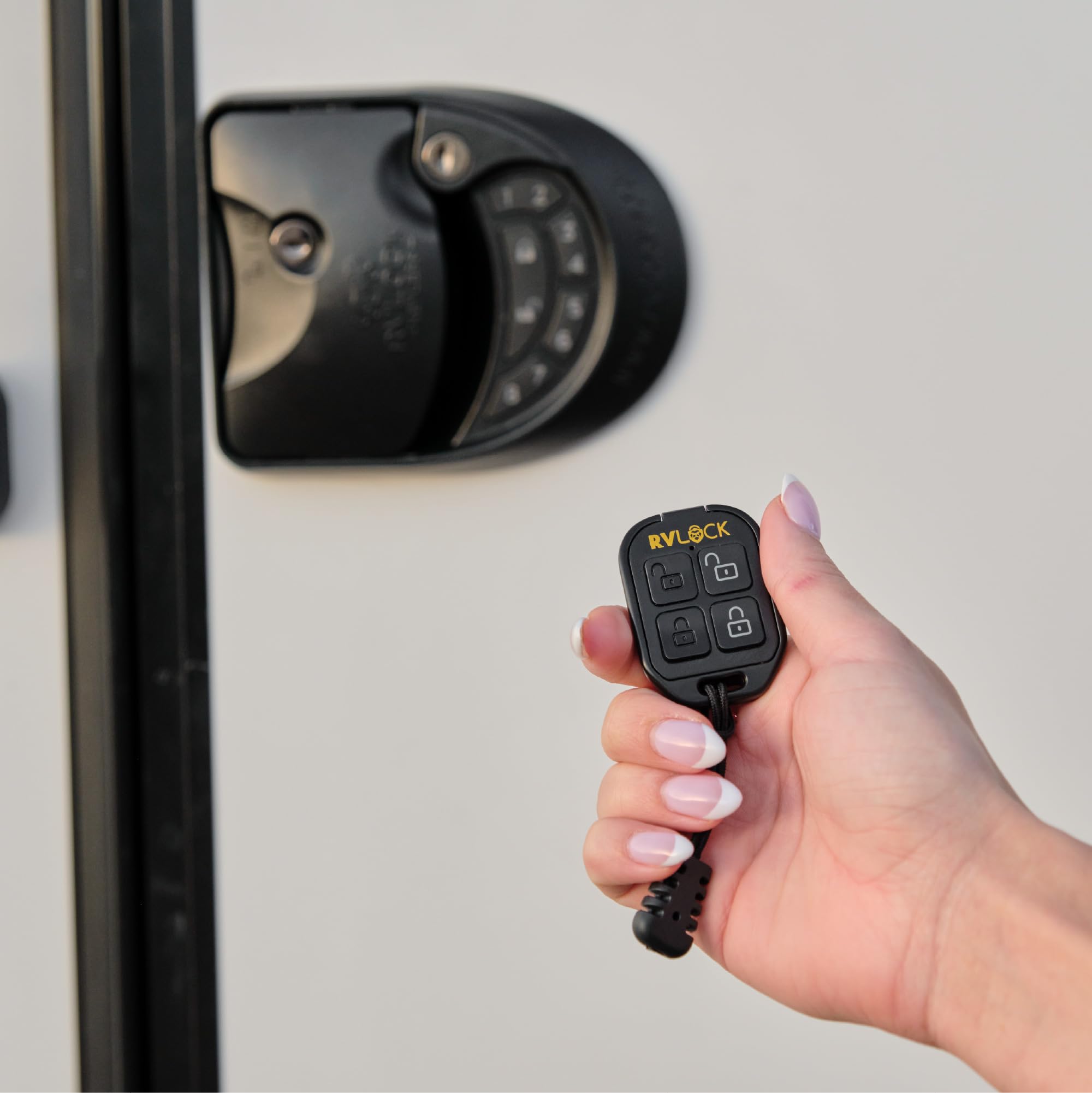 RVLock remote held in hand showing scale and comfortable one-handed use