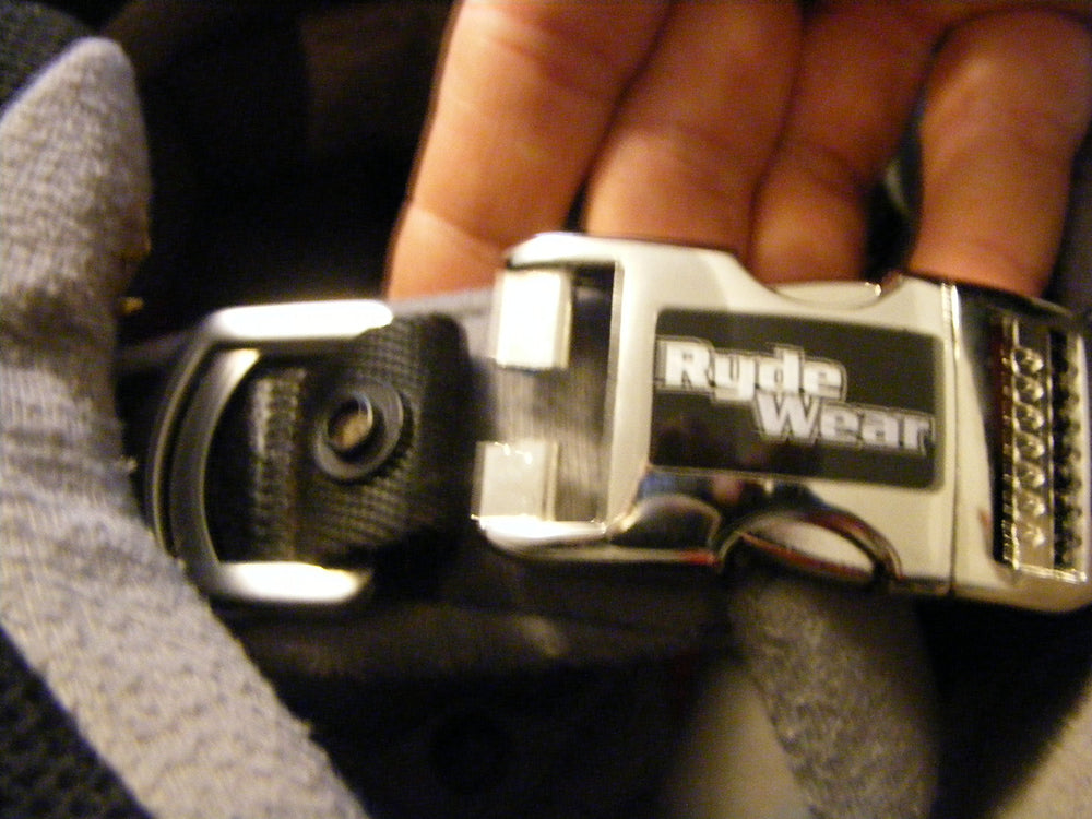 Shubandit RydeWear in-use rider fastening buckle while wearing gloves
