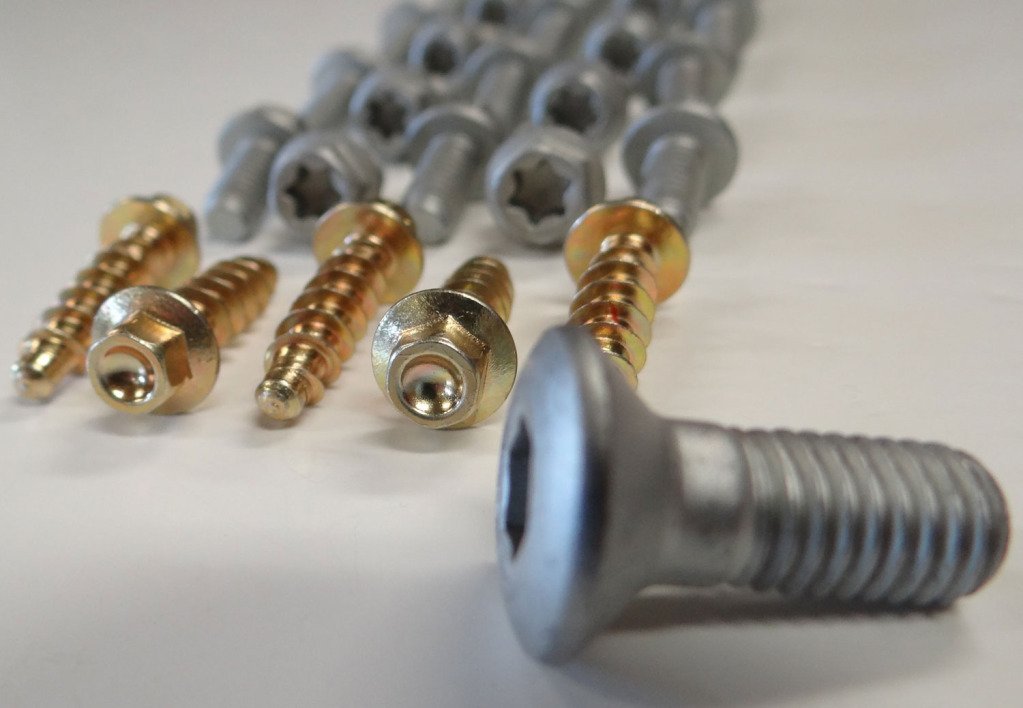 Specbolt closeup of torx flange bolts and washers showing plated finish and corrosion resistance