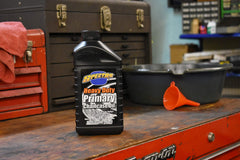 Spectro Oil being poured into a Harley primary case illustrating easy application and proper fit