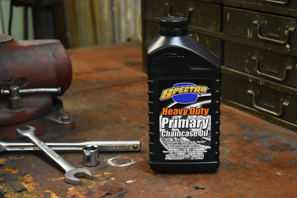 Spectro Oil quart beside Harley parts to show scale and compatibility for Sportster and Big Twin