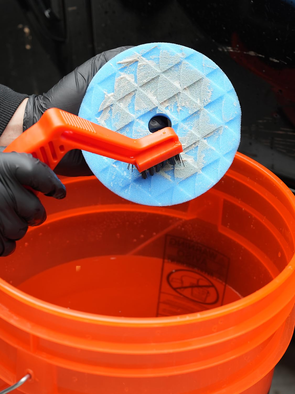 SPTA garage scene with pads and polisher ready for professional detailing