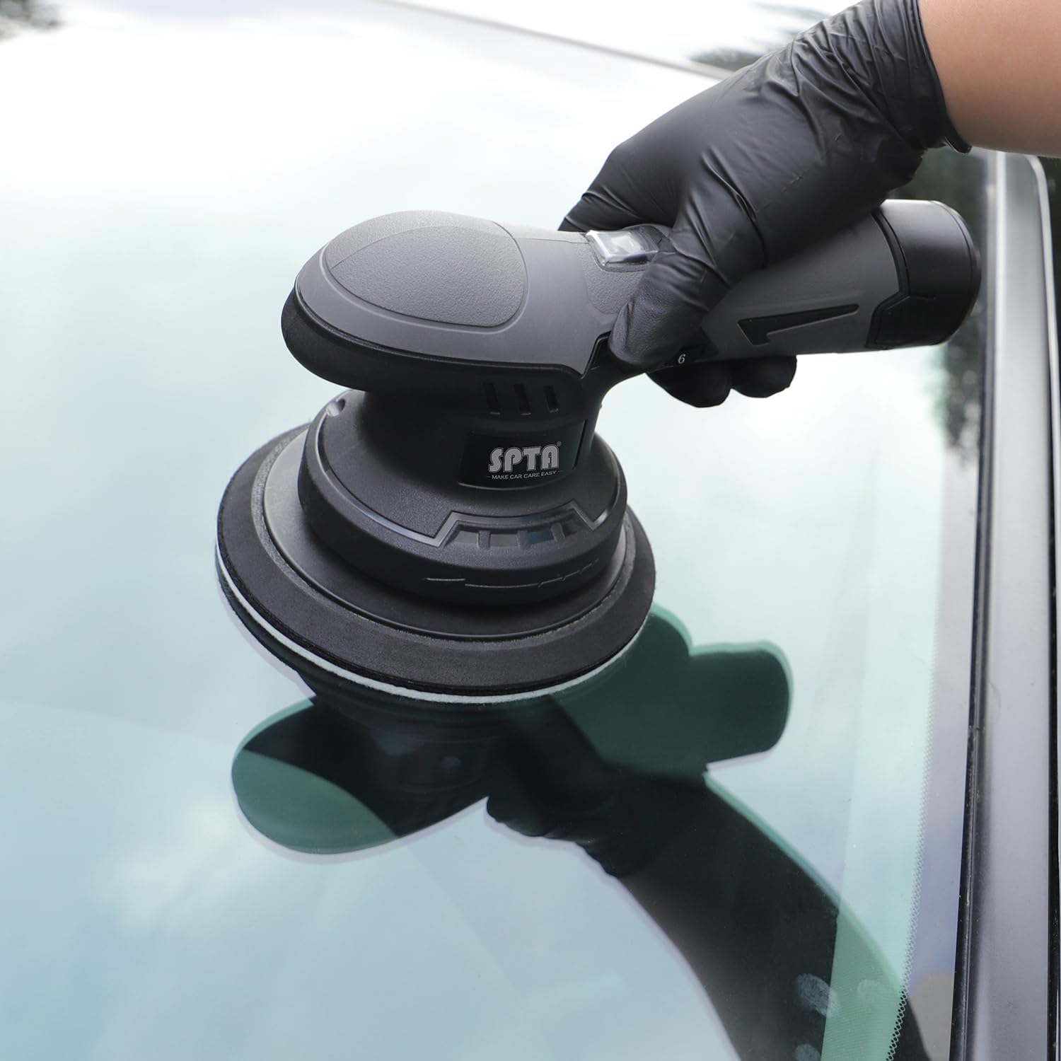 SPTA polishing windshield lifestyle shot illustrating restored clarity