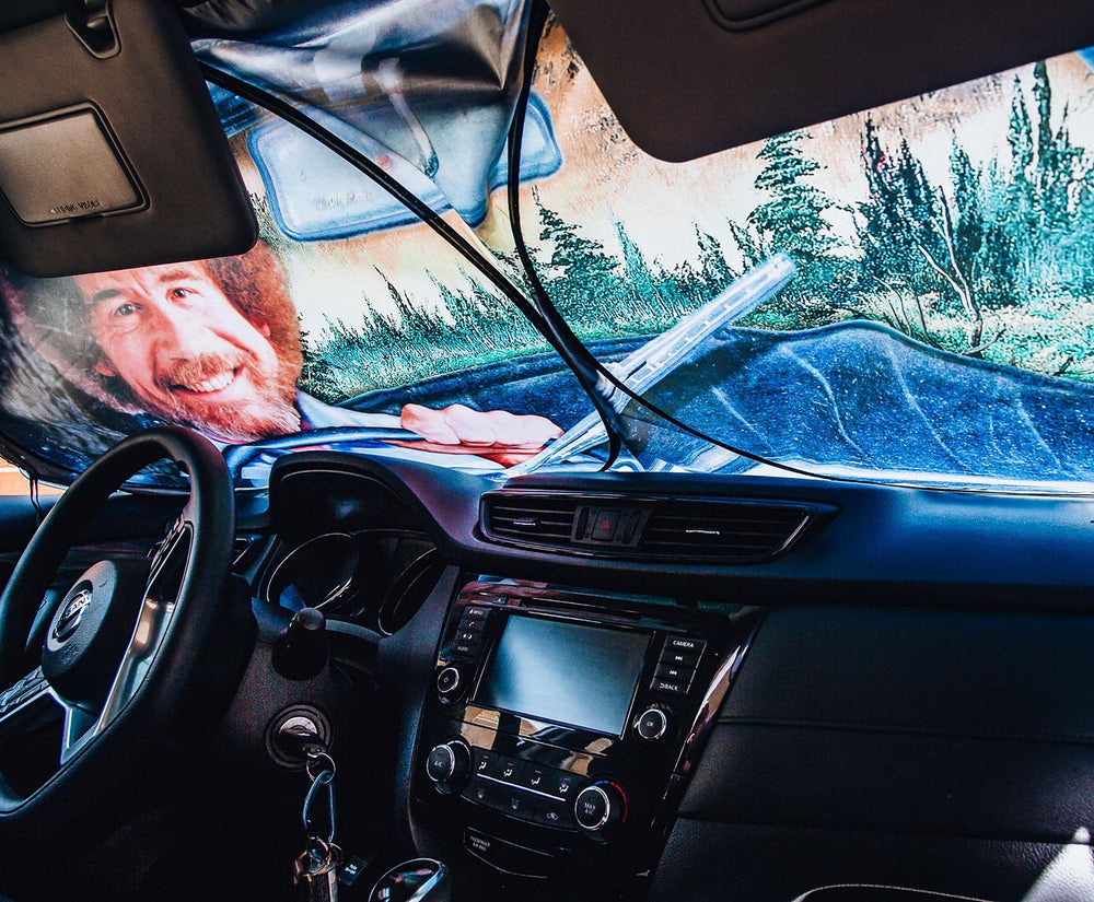 Surreal Entertainment Bob Ross rear-view mirror detail showing painted landscape and charm