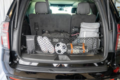 TacoNets envelope net in use holding grocery bags to prevent shifting during travel