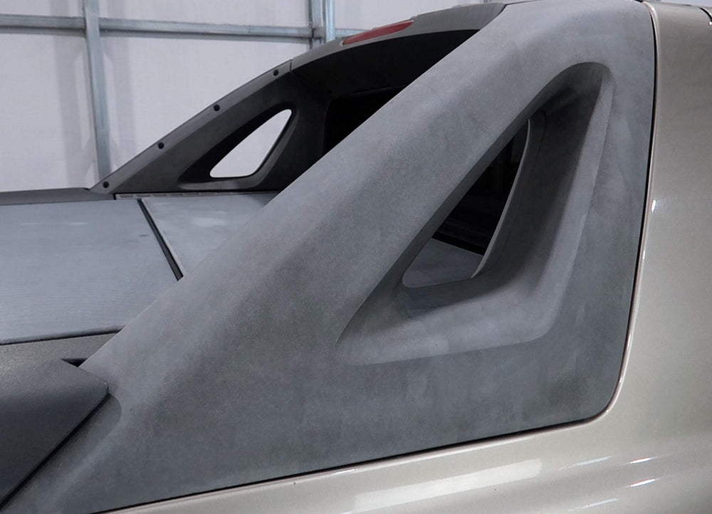That Stuff before and after on car bumper showing restored deep black trim