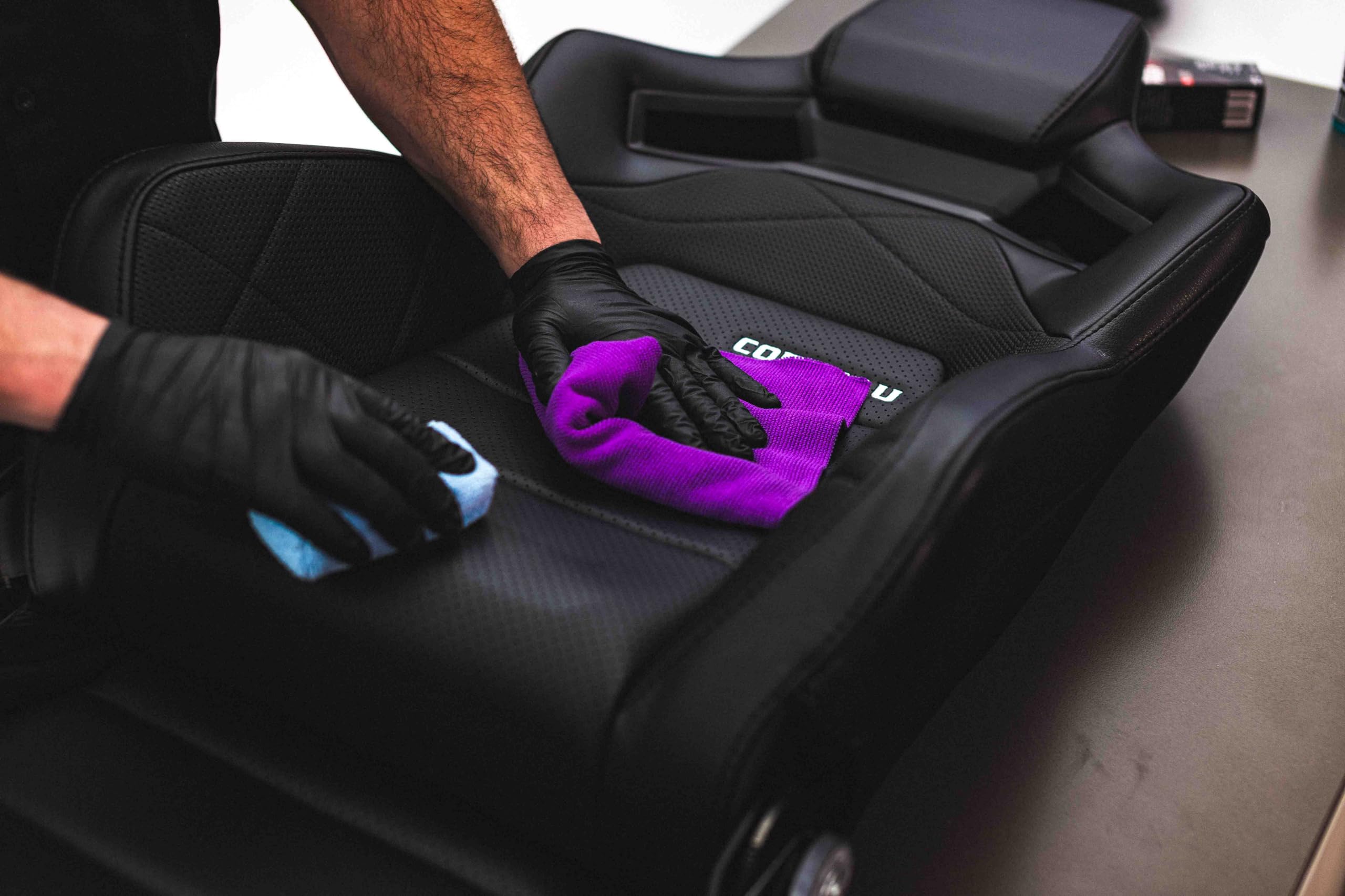 The Rag Company towel staged in a detailing kit lifestyle shot showing professional-ready performance