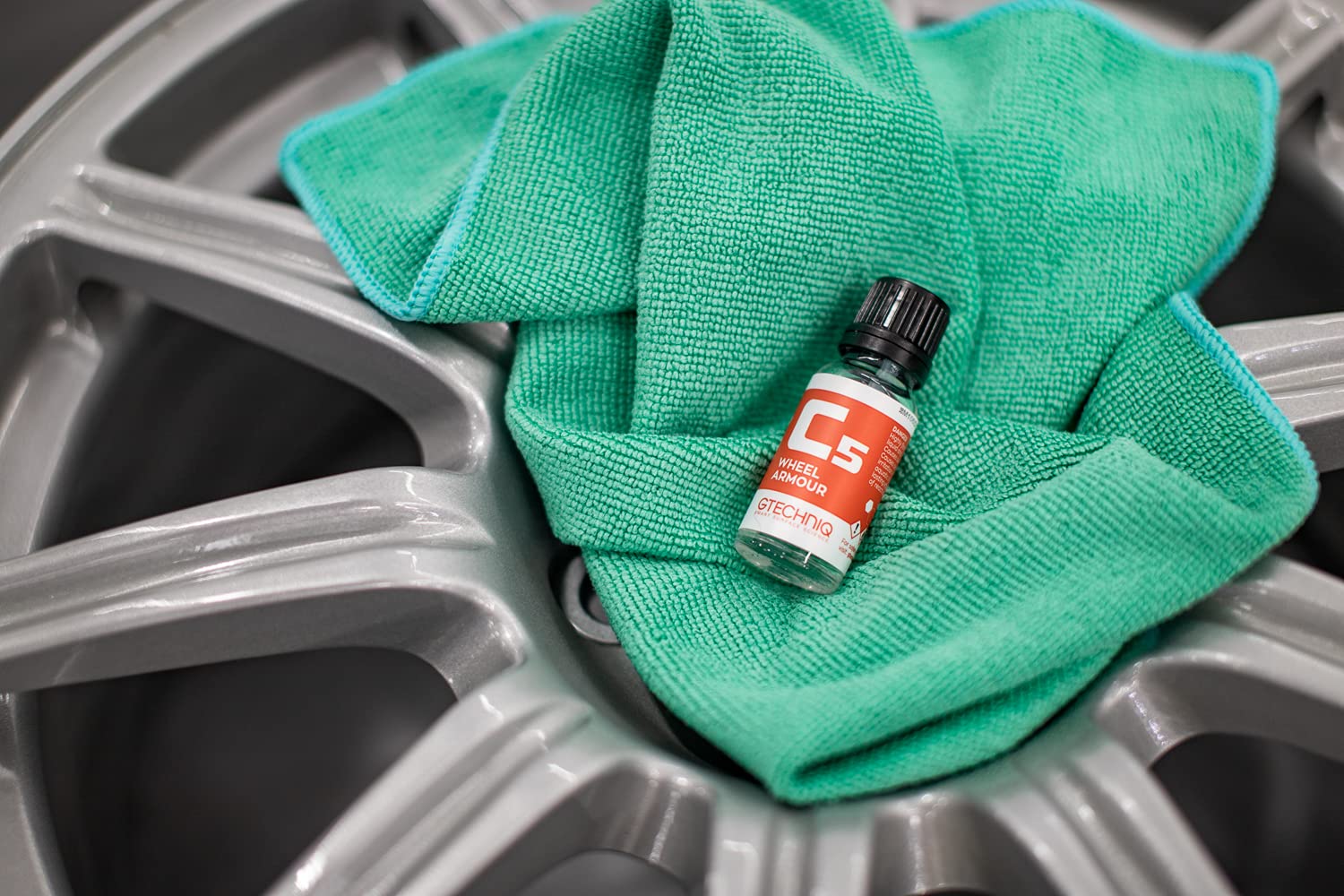 The Rag Company towel touching paint surface illustrating paint-safe contact and scratch prevention