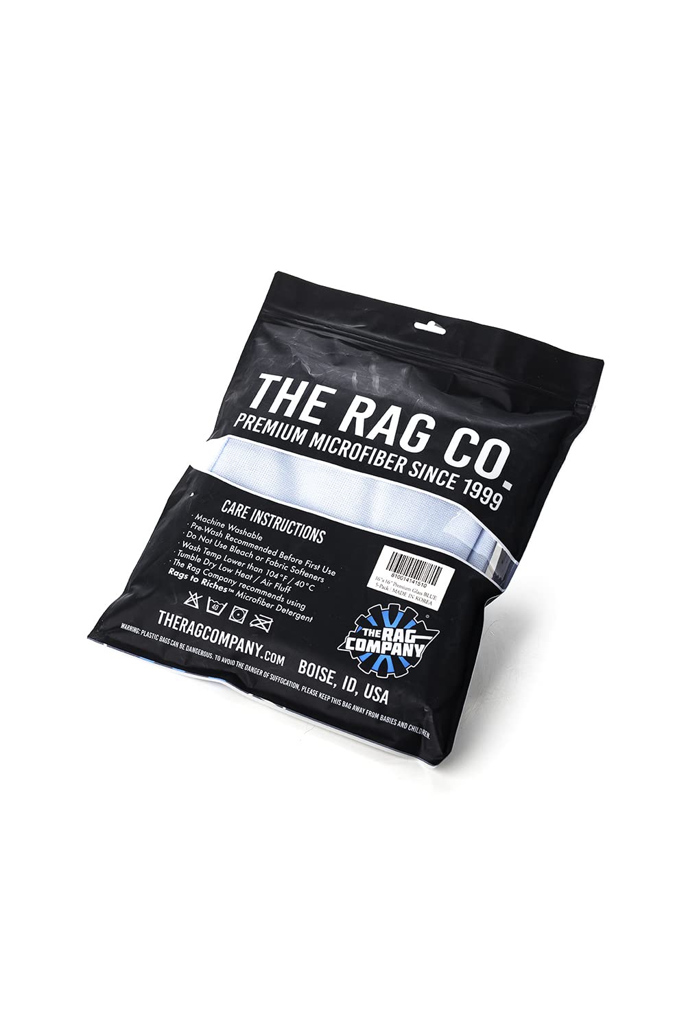The Rag Company towel held next to a hand to show 16x16 size and easy handling for detailers