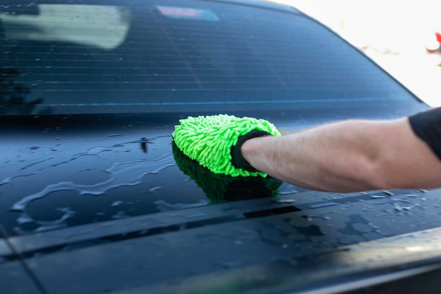 The Rag Company mitt washing a car panel for scratch-free, lubricated cleaning