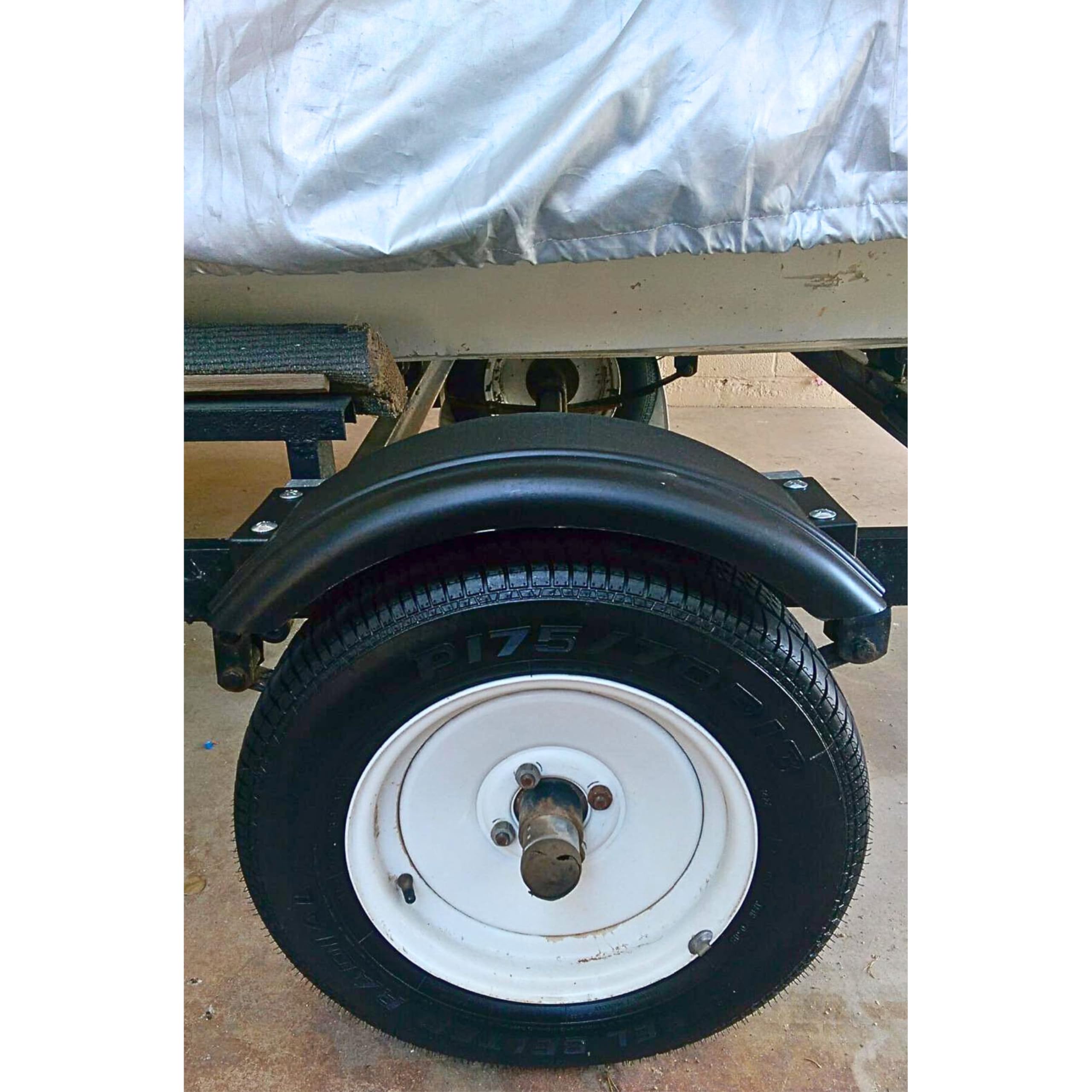 Tie Down fender on trailer driving on road highlighting splash protection