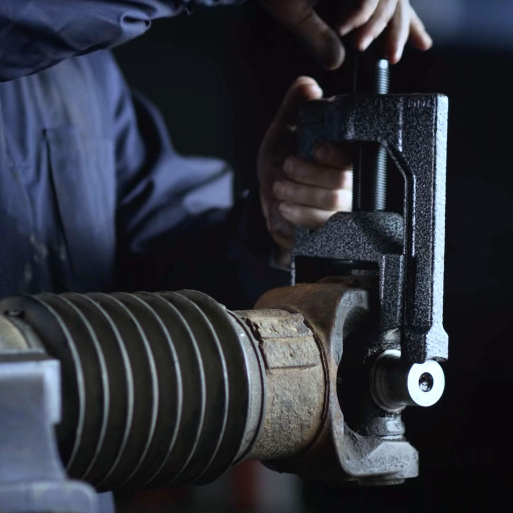 Technician using Tiger Tool showing safer, faster U-joint removal in action
