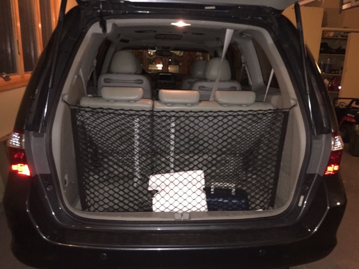 TN TrunkNets lifestyle shot family loading Odyssey trunk for travel