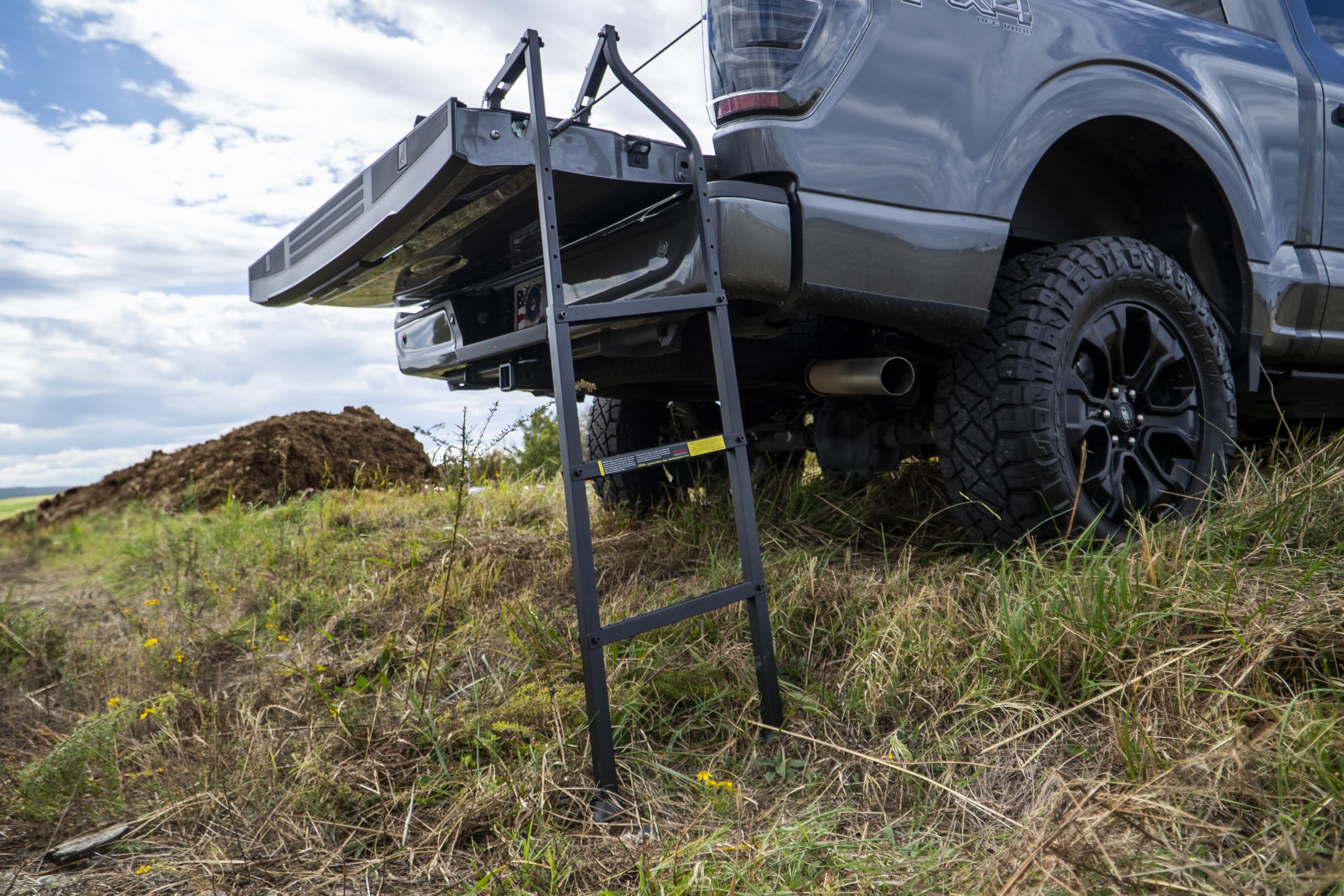 Traxion ladder next to ruler showing size and compatible tailgate range