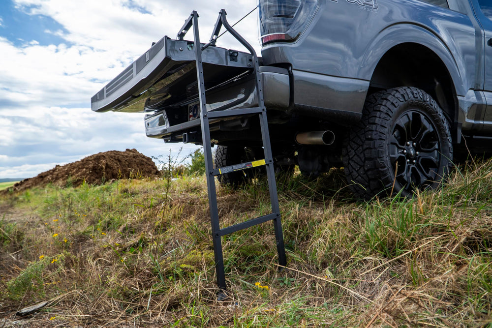 Traxion ladder next to ruler showing size and compatible tailgate range