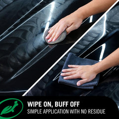 Turtle Wax applicator spreading paste on paint showing smooth application benefit