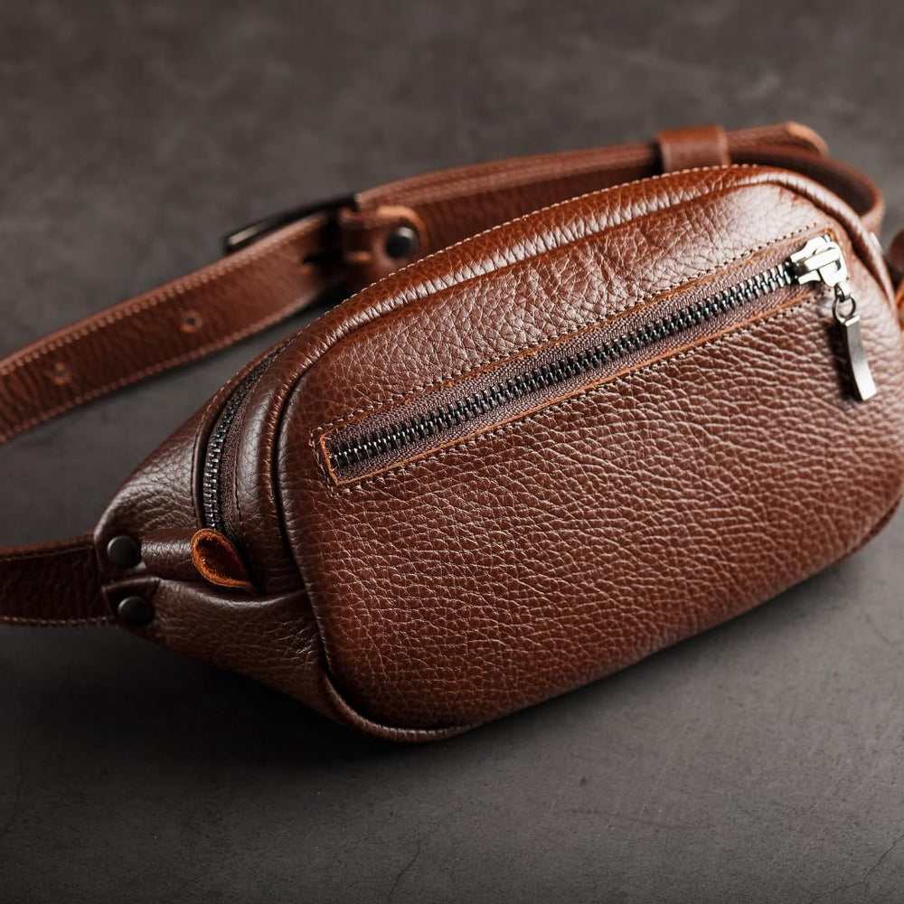 URAD 7oz bottle held next to hand to show compact travel-friendly size