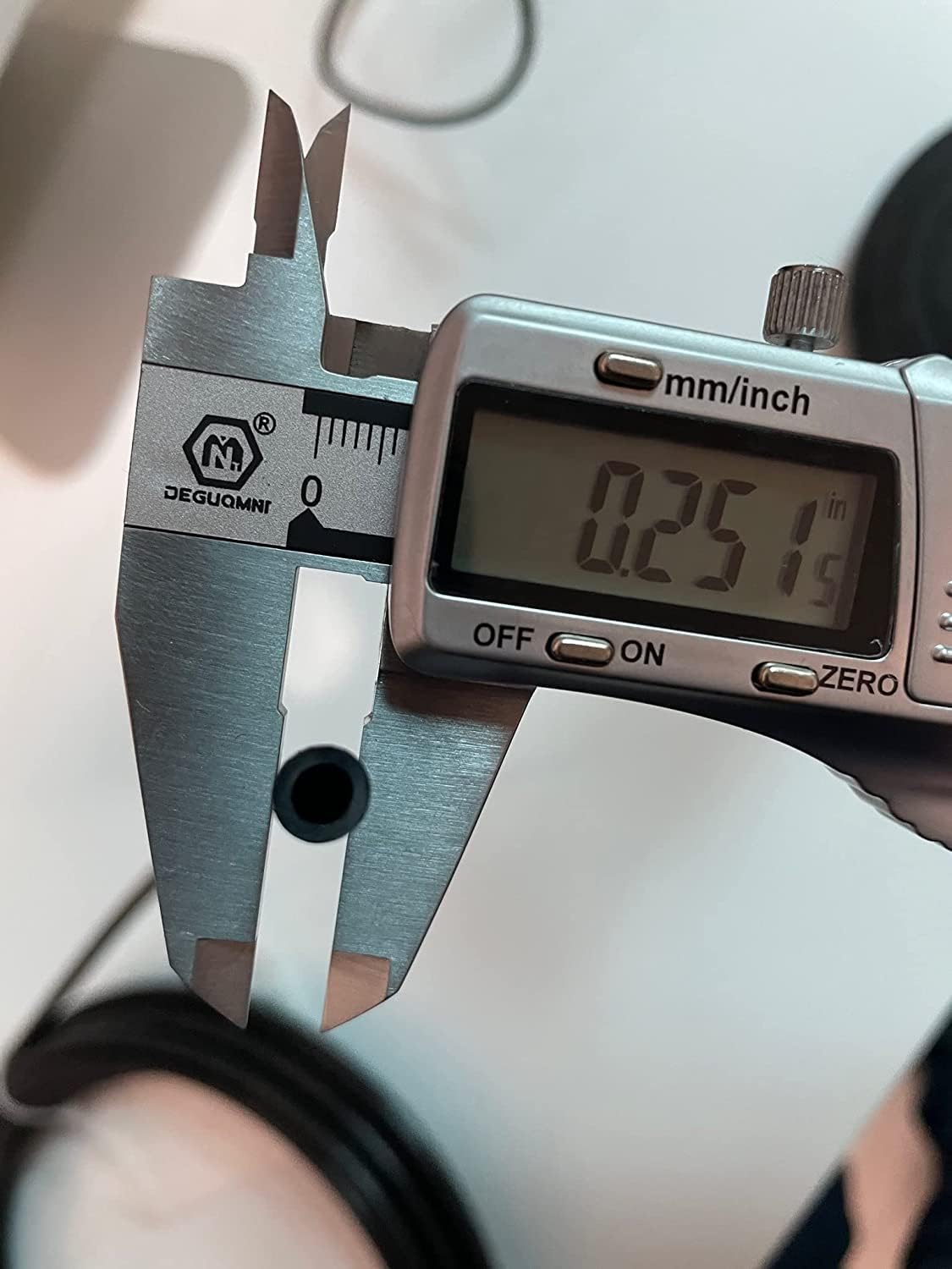 utah pneumatic coil beside a ruler for scale benefit: accurate 100ft length and sizing