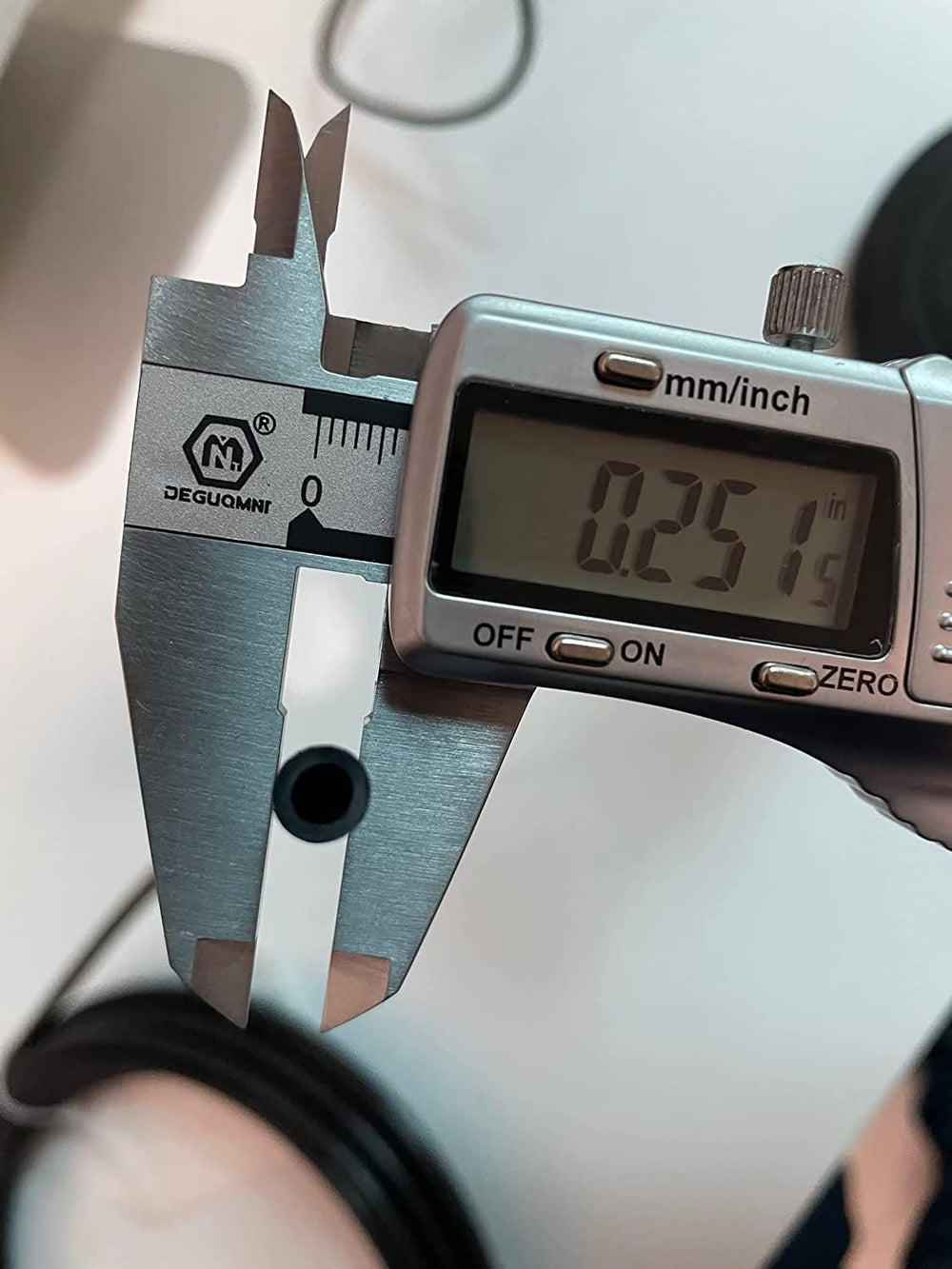 utah pneumatic coil beside a ruler for scale benefit: accurate 100ft length and sizing