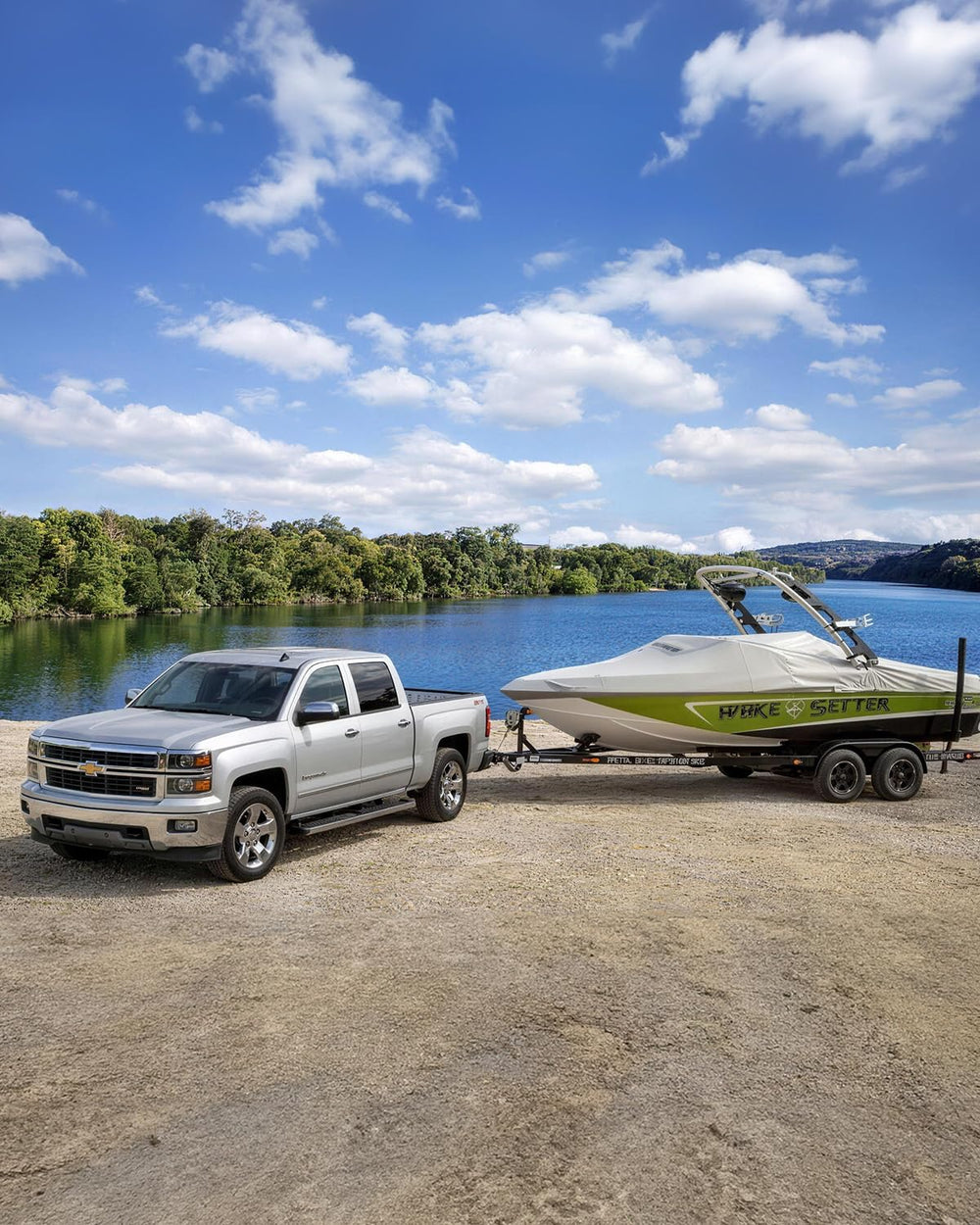 Xprite lifestyle shot towing a trailer with ATV demonstrating versatile hauling ability