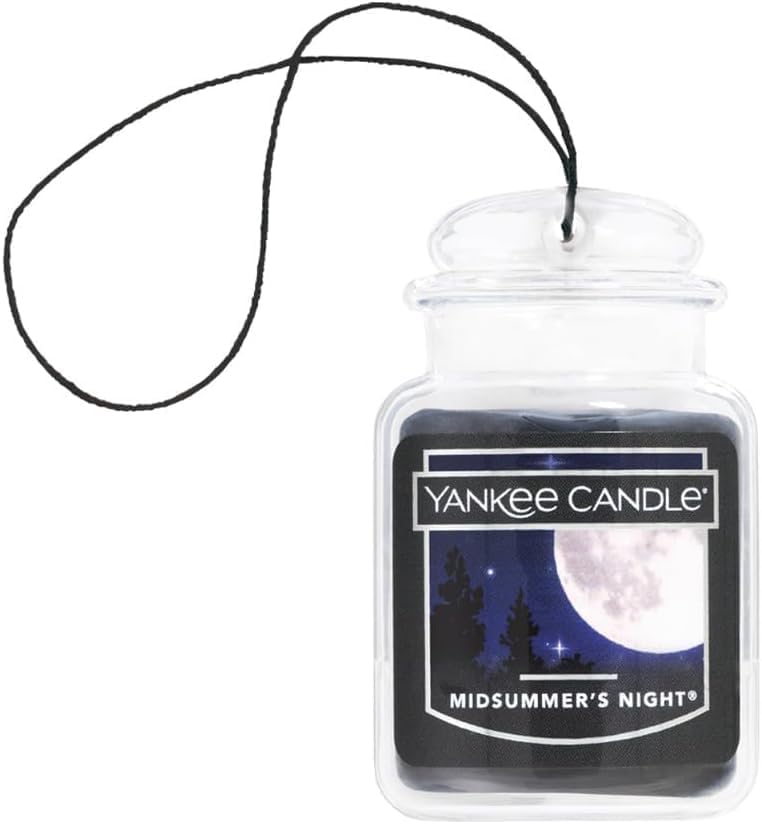 Yankee Candle size comparison with phone showing compact design and portability